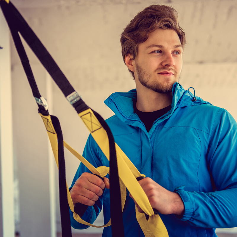 Young man holding TRX bands